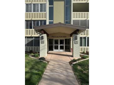 The building's welcoming entrance features modern architecture and professional landscaping at 750 S Alton Way # 8C, Denver, CO 80247