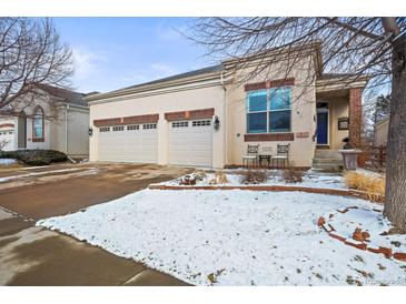 Charming stucco home featuring a spacious two-car garage and a welcoming front entrance at 6700 W Dorado Dr # 51, Littleton, CO 80123