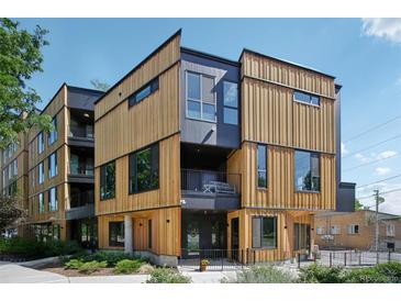 Modern multi-story home features natural wood and dark gray siding with complementary black trim at 1601 Park Ave # 106, Denver, CO 80218