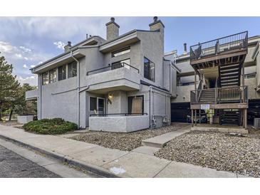 Charming condo exterior with a balcony and well maintained landscaping and stairs to other condos at 1830 Newland Ct # 209, Lakewood, CO 80214