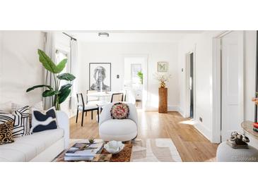 Bright living room with hardwood floors and stylish furniture at 1431 S Emerson St, Denver, CO 80210