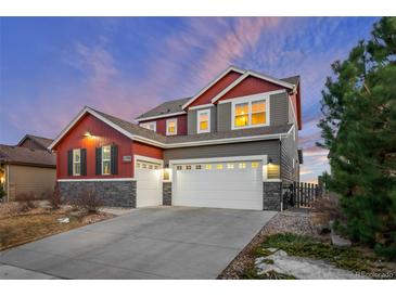 Charming two-story home featuring a three-car garage, stone accents, and appealing color palette at 17786 W 86Th Ln, Arvada, CO 80007