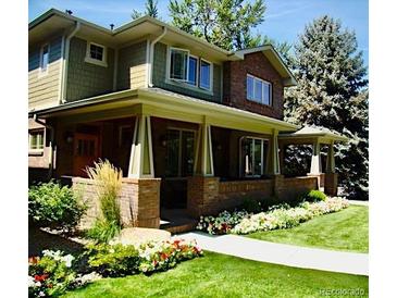 Charming two-story home with a well-manicured lawn and beautiful landscaping, offering great curb appeal at 1907 S Columbine St, Denver, CO 80210