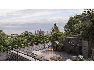 Relaxing rooftop deck with an outdoor grill and comfortable seating offering stunning city views at 4817 W 10Th Ave, Denver, CO 80204