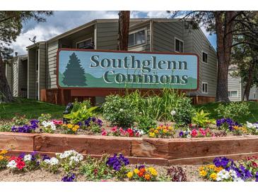 Southglenn Commons community sign, set among colorful flowers and lush greenery at 7275 S Gaylord St # I09, Littleton, CO 80122