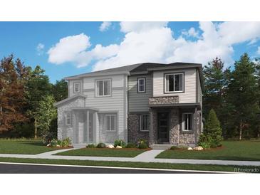 Stylish new two-story home featuring stone accents, large windows, and a well-manicured lawn at 6609 N Netherland St, Aurora, CO 80019