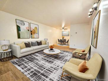 Bright living room with a modern sofa, stylish rug, and contemporary art at 1270 N Marion St # 103, Denver, CO 80218