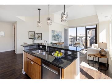 Modern kitchen featuring granite countertops, stainless steel appliances, and island with pendant lighting at 1650 Fillmore St # 504, Denver, CO 80206