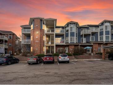 Exterior shot of building with a brick facade and multiple floors, parking in front at 2428 W 82Nd Pl # 2D, Westminster, CO 80031