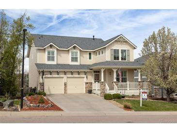 Charming two-story home featuring a covered porch, well-kept lawn, and a two car garage at 743 Briar Haven Dr, Castle Pines, CO 80108