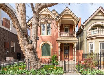 Charming two-story brick home featuring a beautiful front yard and inviting porch with vintage details at 3147 Vallejo St, Denver, CO 80211