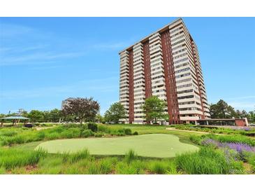 Stunning high-rise building featuring a well-manicured lawn, putting green, and lovely landscaping at 3131 E Alameda Ave # 704, Denver, CO 80209