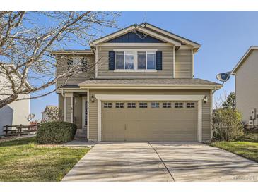 Charming two-story home featuring a two-car garage and well-maintained front lawn at 9605 Elk Mountain Cir, Littleton, CO 80125