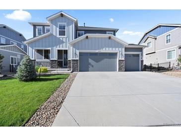 Beautiful two-story home with a three-car garage and landscaped front yard at 1665 Diamond Head Dr, Castle Rock, CO 80104