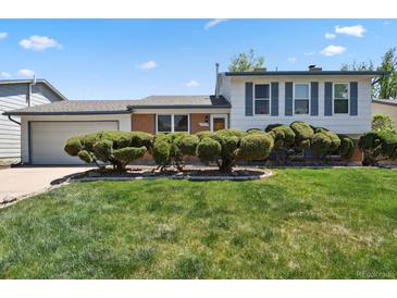 Charming home featuring a well-manicured lawn and trimmed shrubbery in the front yard at 2554 S Laredo Ct, Aurora, CO 80013