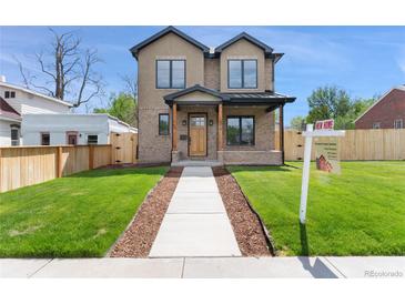 Charming two-story home featuring a manicured lawn, complemented by a welcoming walkway and a 'New Home' sign at 1970 S Logan St, Denver, CO 80210