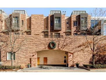 Brick building exterior with covered entryway and landscaping at 105 Fillmore St # 204, Denver, CO 80206