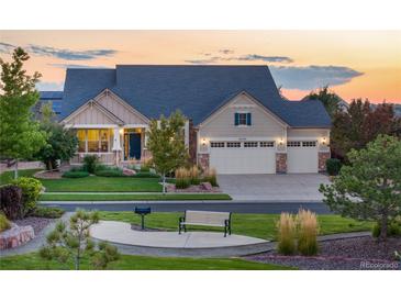 Charming home with a three-car garage, a well-manicured lawn, and lovely landscaping at 27235 E Lakeview Pl, Aurora, CO 80016