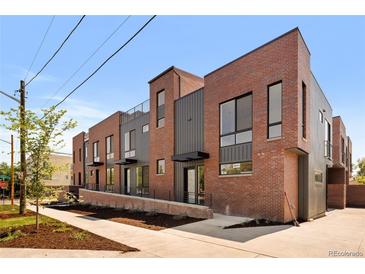 Beautiful brick townhomes featuring modern architectural design and inviting entrances at 2012 W 46Th Ave, Denver, CO 80211