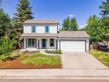 Charming two-story home with white exterior, trimmed windows and front two-car garage at 655 Gooseberry Ct, Lafayette, CO 80026