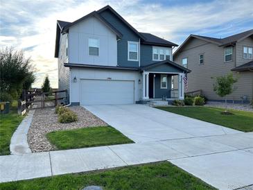 Two-story home with a large driveway, attached garage and well-manicured lawn at 12901 Crane River Dr, Longmont, CO 80504