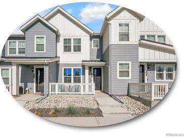 Charming townhome with gray siding, white accents, and inviting front porch area at 2059 S Vance Way, Denver, CO 80227