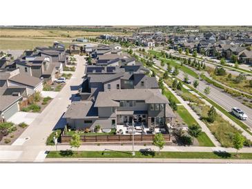 Stunning aerial view of a home with solar panels, back patio, and landscaping in a vibrant neighborhood at 9741 Taylor River Cir, Littleton, CO 80125