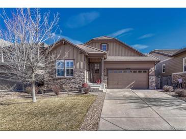 Charming home with stone accents, a two-car garage, and a well-maintained front yard at 12732 Fisher Dr, Englewood, CO 80112