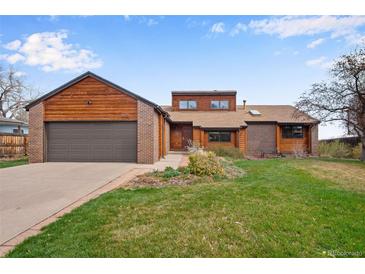 Charming single-Gathering home with brick and wood exterior, two-car garage, and well-maintained lawn in a quiet neighborhood at 11875 W 107Th Ave, Broomfield, CO 80021