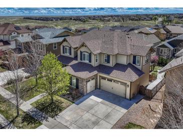Beautiful two-story home featuring a two-car garage, well-manicured lawn, and lovely landscaping at 26566 E Peakview Dr, Aurora, CO 80016
