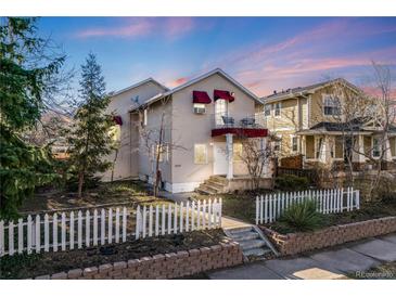 Charming home with a white picket fence, lush trees, and a cozy balcony; perfect for enjoying the outdoors at 2047 S Franklin St, Denver, CO 80210