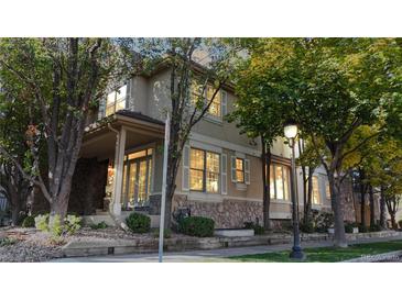 Charming home with stone accents and ample natural light streaming through the shuttered windows at 203 S Jackson St, Denver, CO 80209