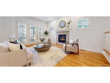 Bright living room with fireplace, hardwood floors, and stylish furnishings at 203 S Jackson St, Denver, CO 80209