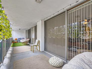 Comfortable patio features sliding glass doors, chairs and decor creating the perfect place to relax at 1155 Ash St # 202, Denver, CO 80220