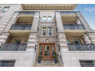 A stunning view of the apartment building with ornate architecture and balconies at 1210 E Colfax Ave # 301, Denver, CO 80218