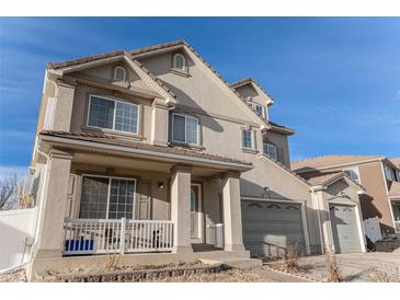 Attractive two-story home featuring a welcoming front porch and an attached two-car garage at 21093 E 53Rd Ave, Denver, CO 80249