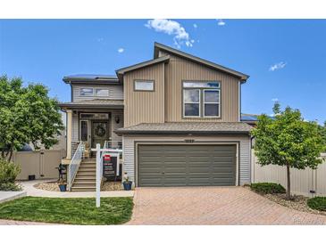 Two-story home featuring neutral siding, a two car garage, and a well-manicured front yard at 5153 Andes Way, Denver, CO 80249