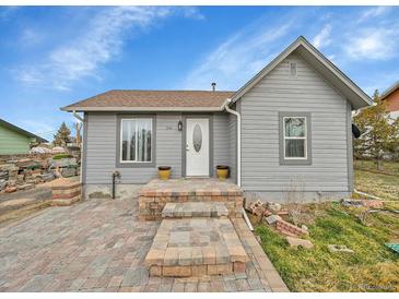 Charming single-story home with a well-maintained front yard and a welcoming entryway at 244 S Fetzer St, Byers, CO 80103