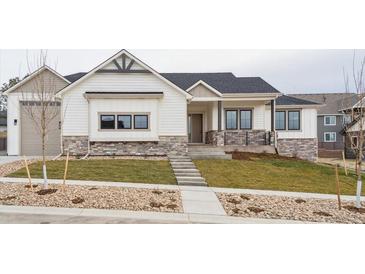 Charming single-story home featuring stone accents, black trim windows, and a well-manicured front yard at 1361 Art Dr, Berthoud, CO 80513