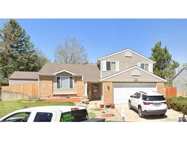 Two-story house with attached garage and landscaped yard at 5171 S Quintero St, Centennial, CO 80015