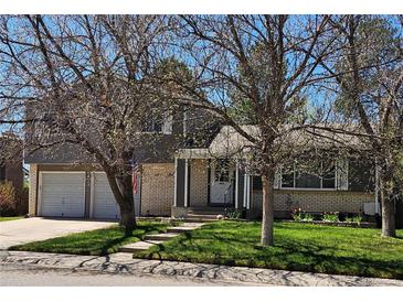 Charming two-story home with attached two-car garage, brick and siding and a well-maintained lawn at 4609 S Kalispell Way, Aurora, CO 80015