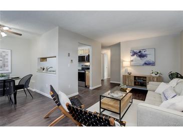 Open layout of living and dining areas with modern furnishings, creating a stylish and functional space at 5873 S Prince St # 117C, Littleton, CO 80120