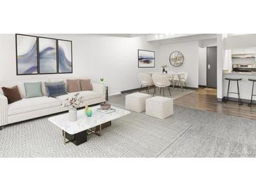 Open living room features hardwood floors, a comfy sofa, and a dining area at 777 N Washington St # 1103, Denver, CO 80203