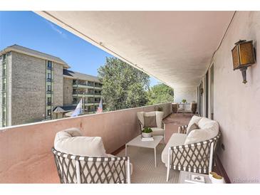 Inviting balcony with comfortable seating offers a relaxing outdoor living space with neighborhood views at 1250 N Humboldt St # 201, Denver, CO 80218