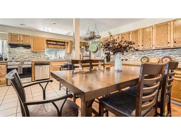 Kitchen/dining area with a view of wooden cabinets and stainless steel appliances at 33 L Rd, Golden, CO 80403