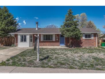 Charming brick home featuring a well-maintained lawn and inviting curb appeal at 8325 Elati St, Denver, CO 80221