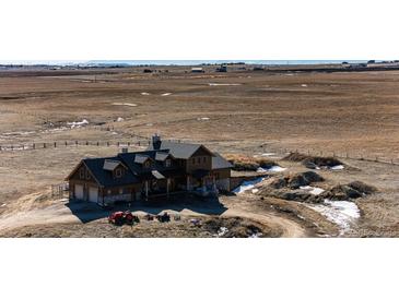 Beautiful home boasts a sprawling landscape, stone accents, and an attached garage, offering both style and functionality at 2710 Rustlers Canyon Loop, Elizabeth, CO 80107