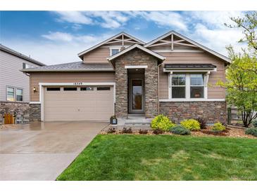 Charming two-story home with stone accents, manicured lawn, and a two-car garage at 16549 Prospect Ln, Broomfield, CO 80023