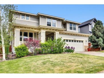 Charming two-story home with manicured lawn and lovely landscaping at 11670 S Flower Mound Way, Parker, CO 80134