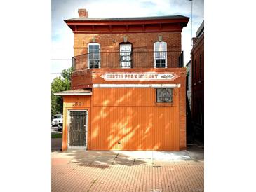 Charming red brick two-story building featuring a 